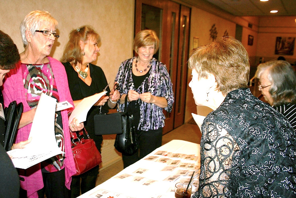 Ellen Dick Mandernack, guest and Carol Dostal Meinert check in.