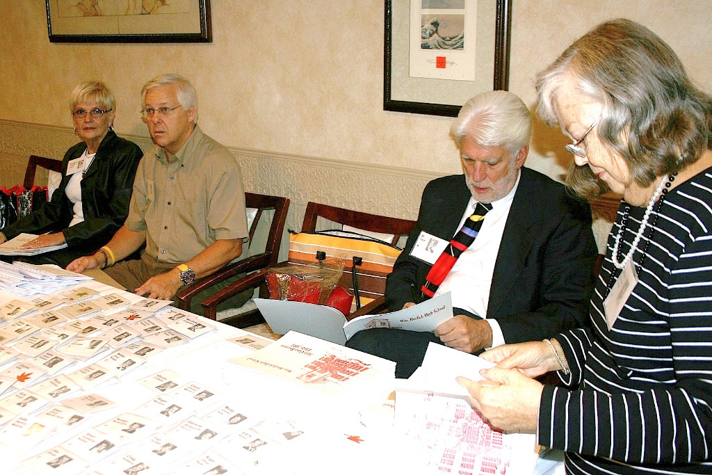 Alex checks out the Reunion Booklet.