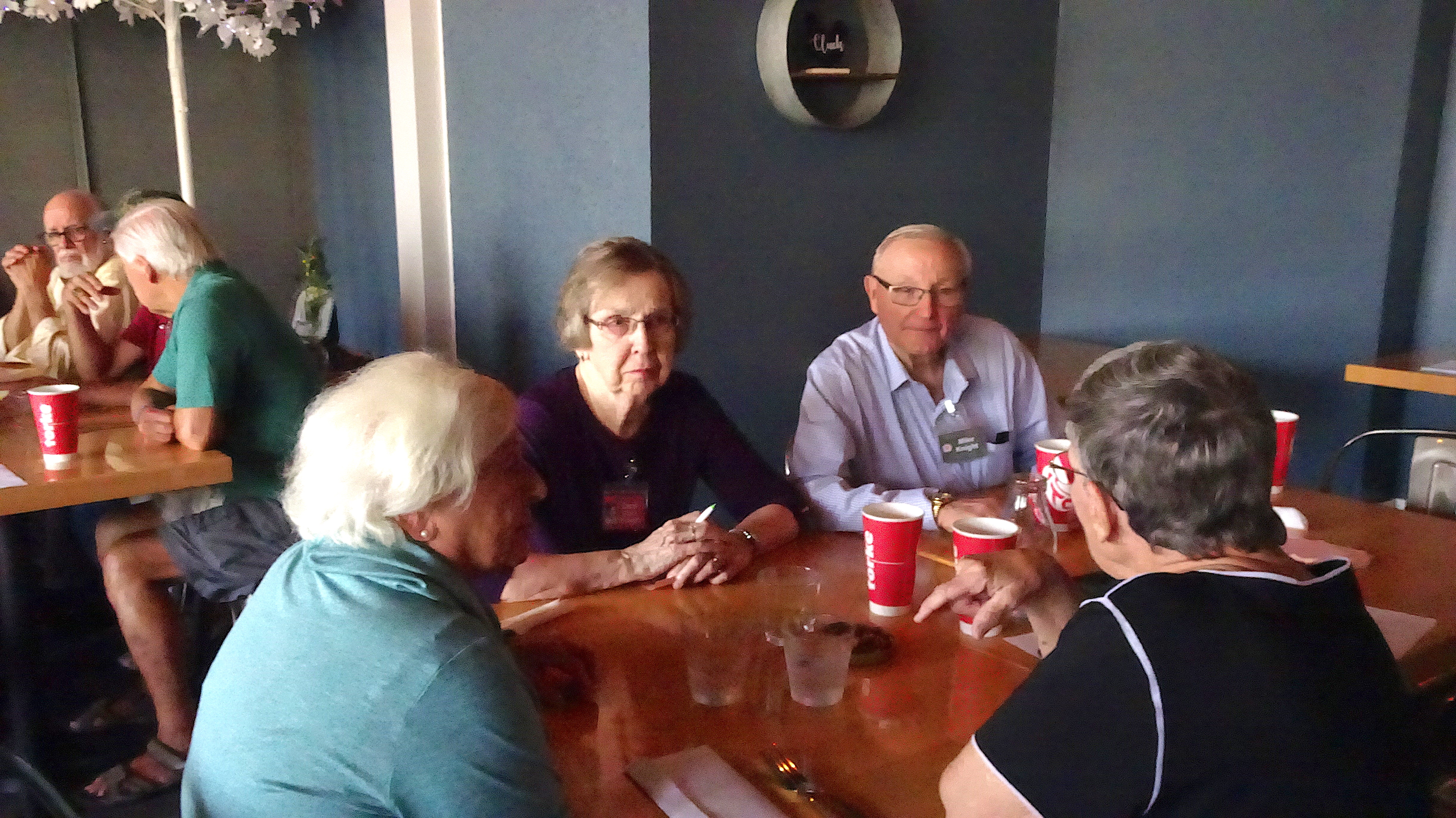 Barb Morgan White, Carol Clark Knight & husband Mike talk with Gretchen Jensen.